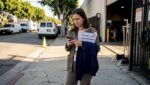 Film worker checks phone near Culver City studio