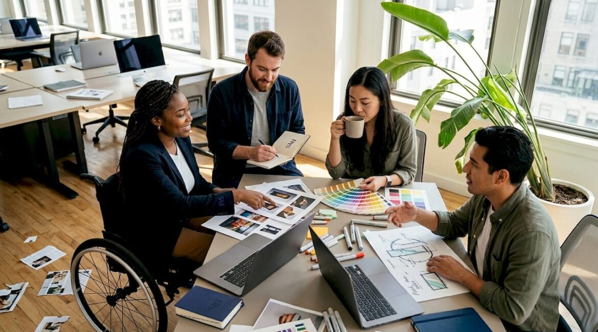 Creative agency team collaborating around workspace